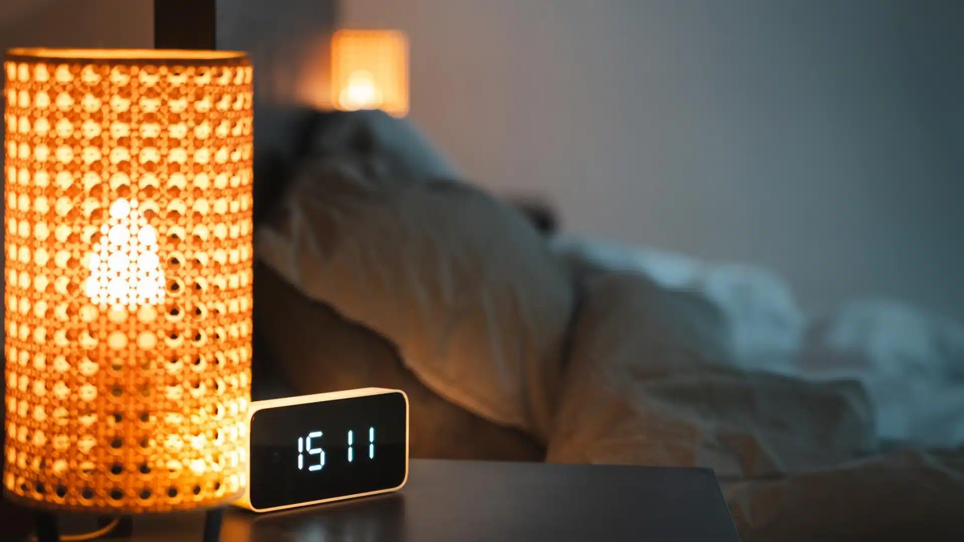 Health Hub 65 Digital alarm clock and bedside lamp in dim bedroom