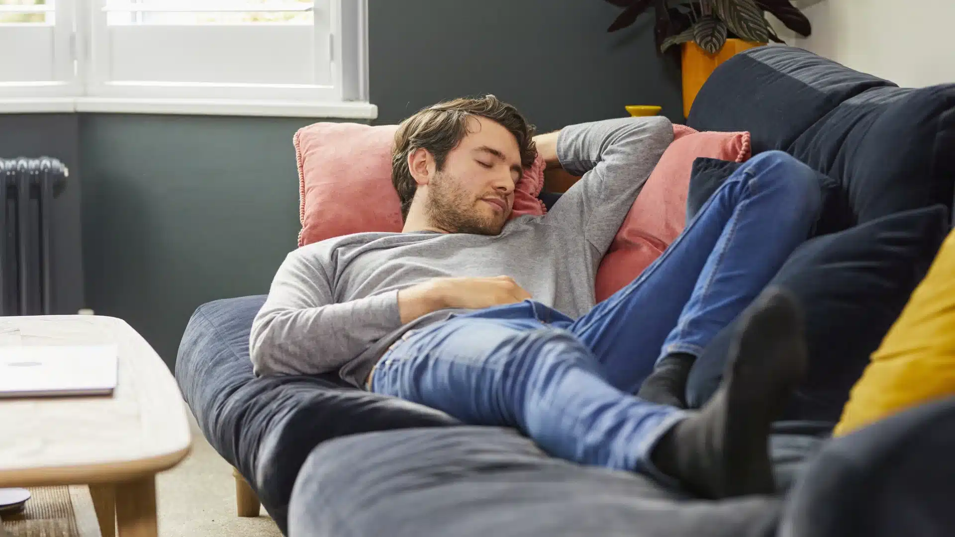 Health Hub 13 Young man sleeping on sofa during daytime, taking afternoon nap in casual clothes