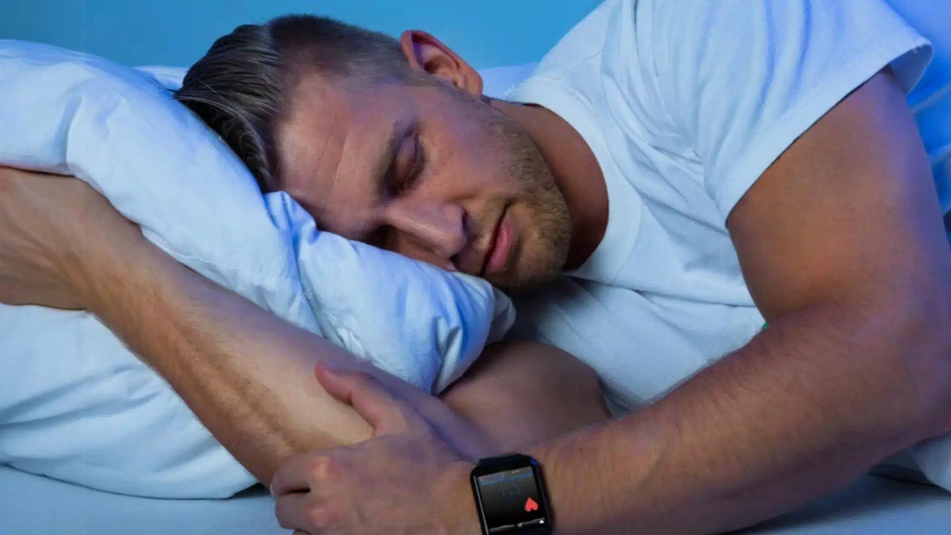 Health Hub 46 Man sleeping with smartwatch tracking heart rate and sleep patterns