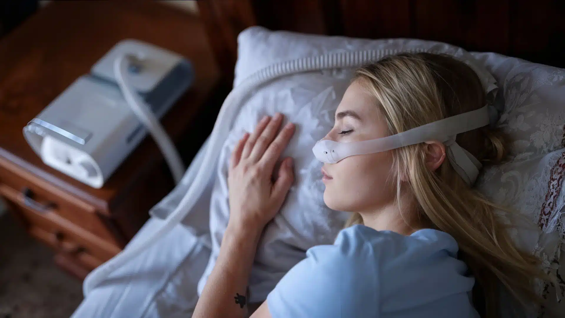 Health Hub 1 Woman sleeping with CPAP nasal mask for sleep apnea treatment at home