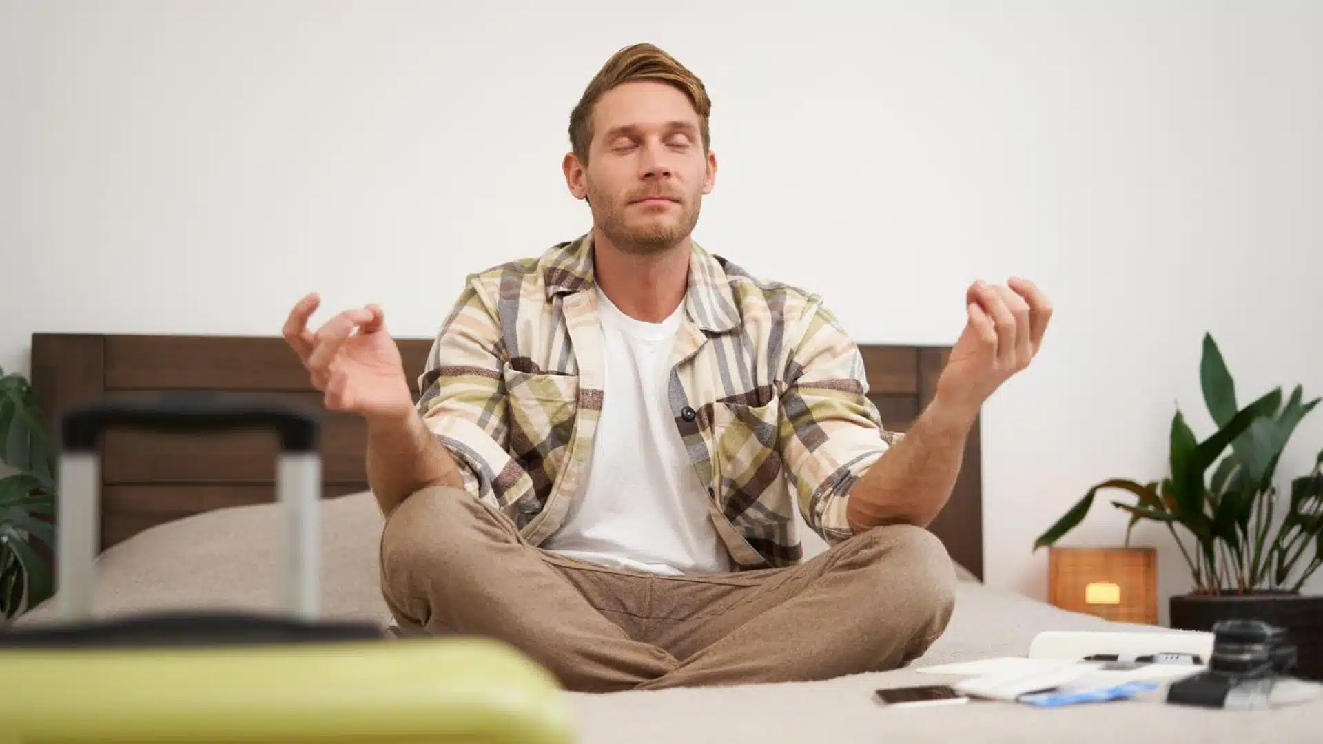 Health Hub 50 Man practicing meditation on bed for stress relief and better sleep