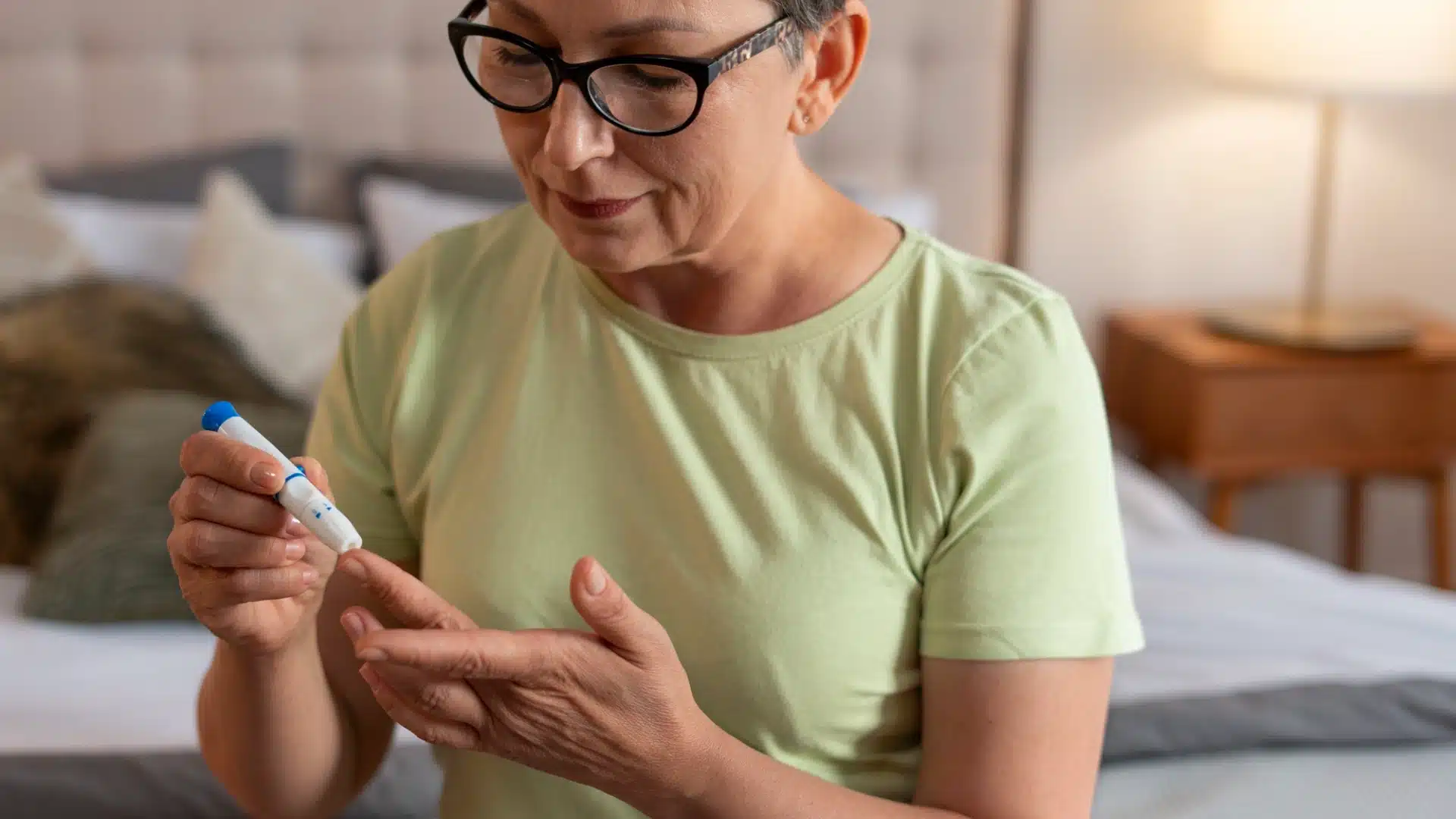 Health Hub 49 Woman checking blood sugar level at home using glucometer for diabetes management