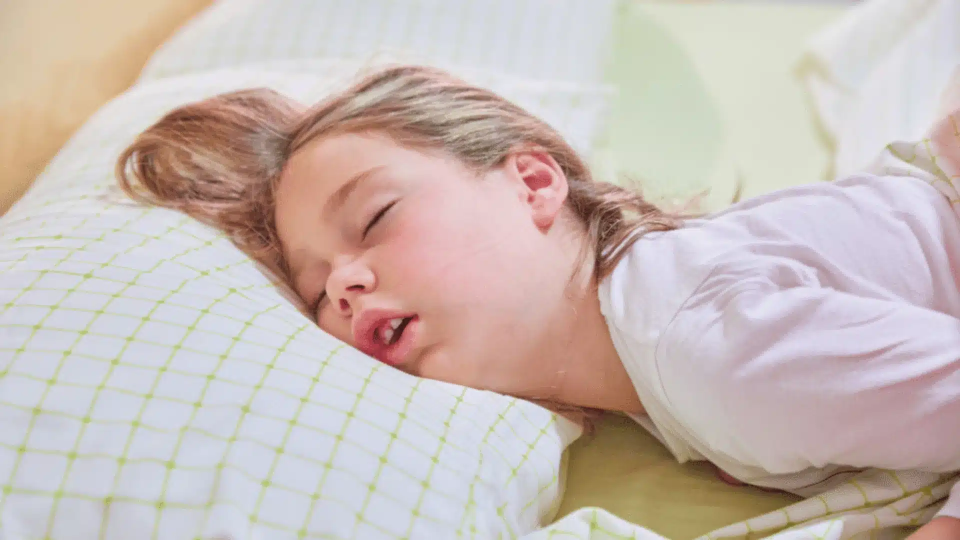 Health Hub 56 Young child sleeping with mouth open, showing possible snoring or pediatric sleep apnea symptoms