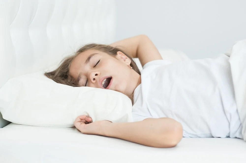 Health Hub 38 Child sleeping with mouth open showing signs of snoring and possible sleep apnea