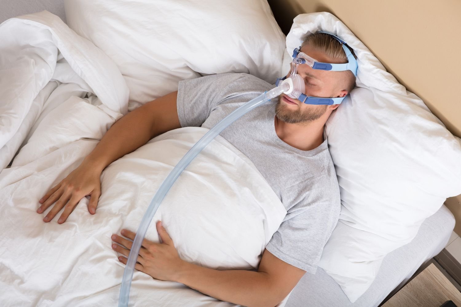 Health Hub 30 Man sleeping with CPAP mask for sleep apnea treatment