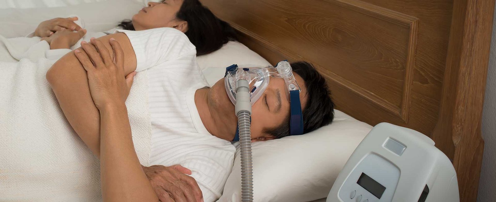 Health Hub 63 Man sleeping with CPAP machine and mask for sleep apnea