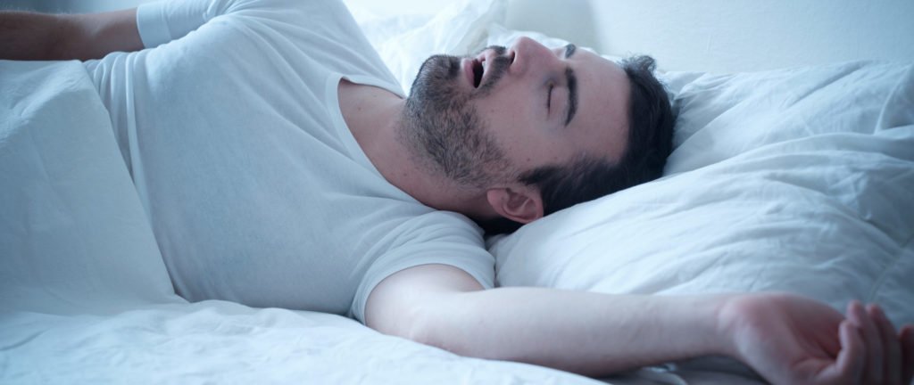 Health Hub 76 Man sleeping on bed with mouth open
