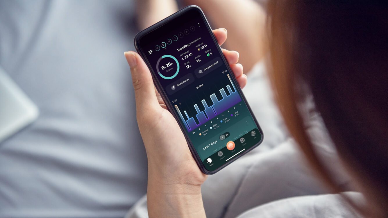 Health Hub 77 Person holding smartphone showing sleep tracking app data
