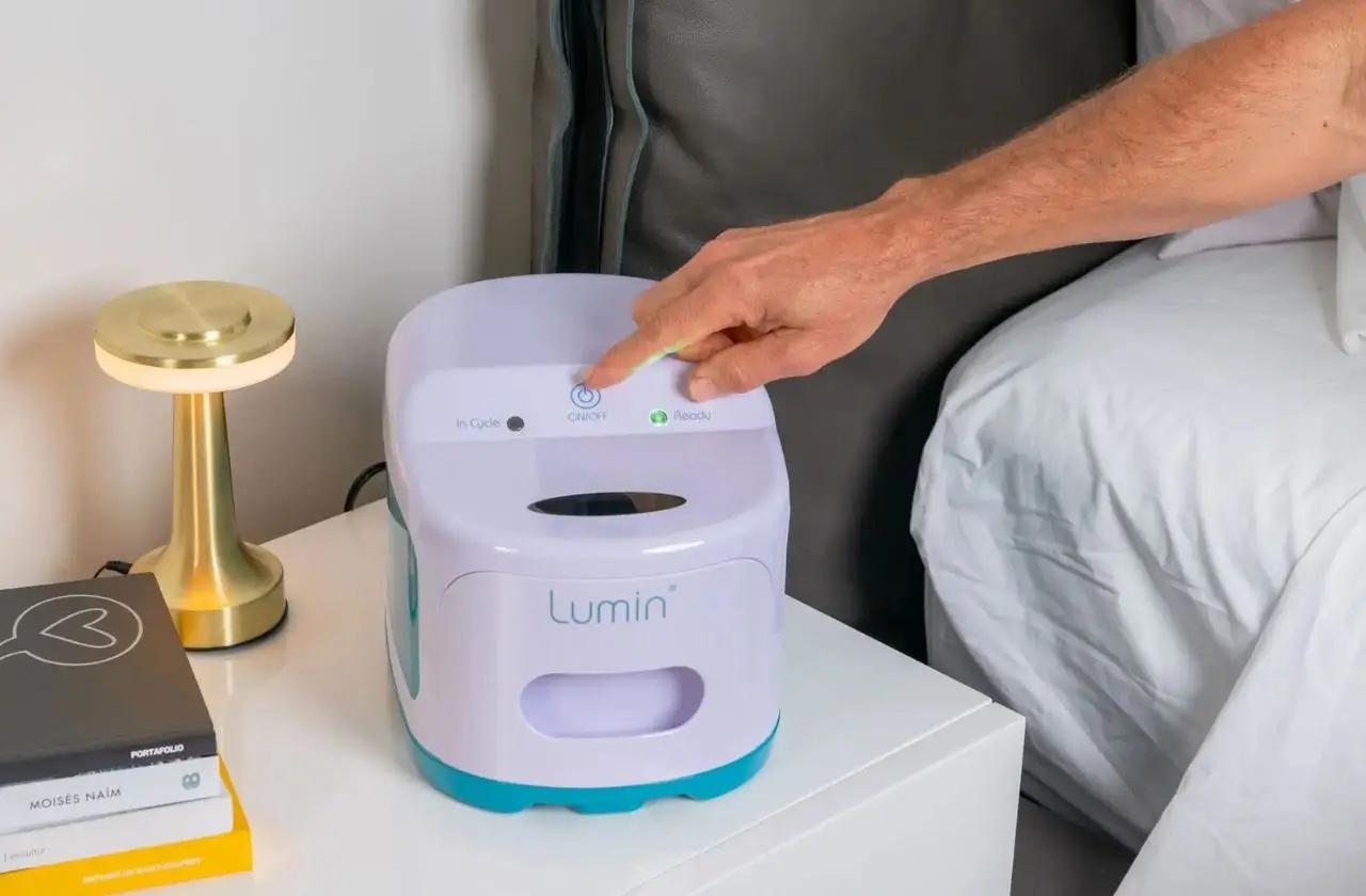 Health Hub 61 Person using Lumin CPAP cleaner on bedside table